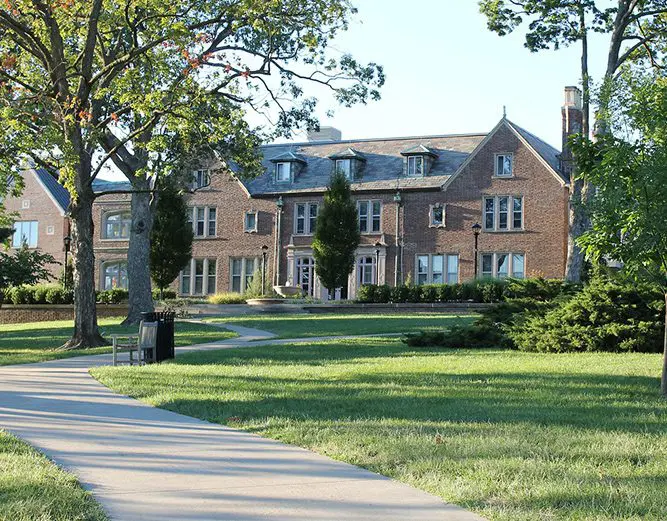 A large brick building with trees in front of it.